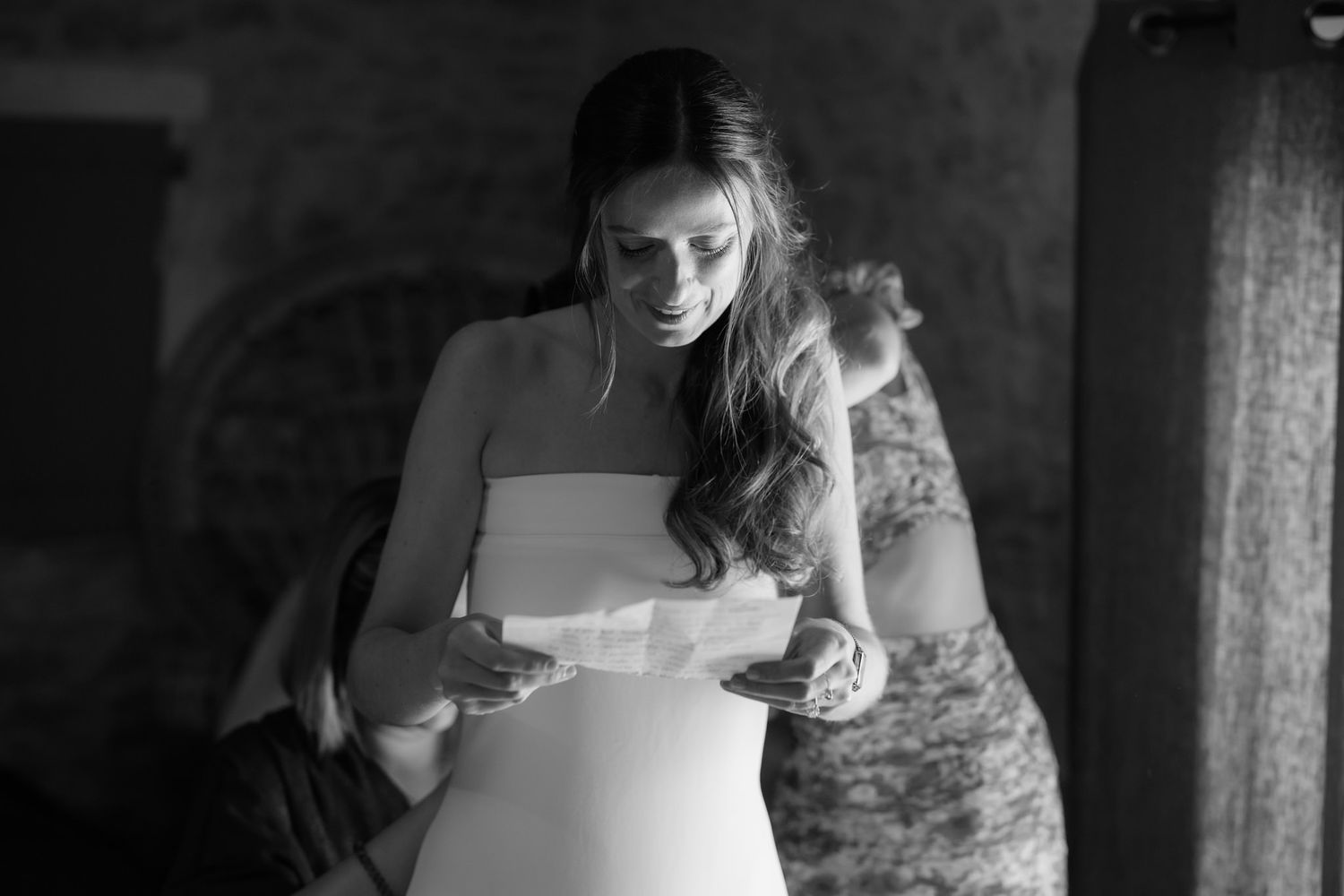 Close-up details of a white wedding dress being fitted and adjusted.