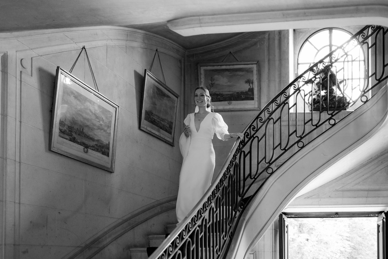 Interior shots of an elegant staircase with wrought iron railings in a historic building.