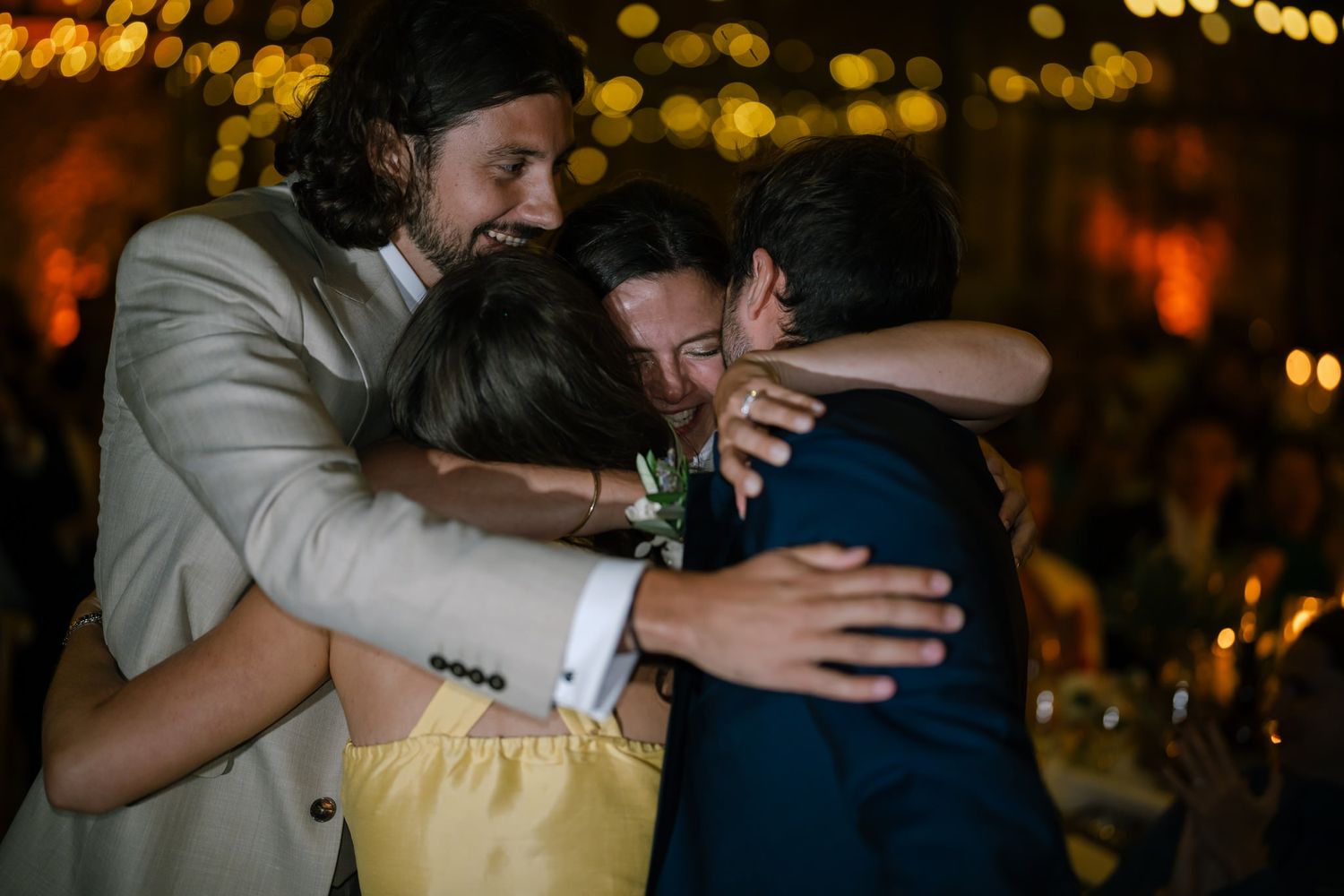 Emotional embraces shared during a festive evening celebration.