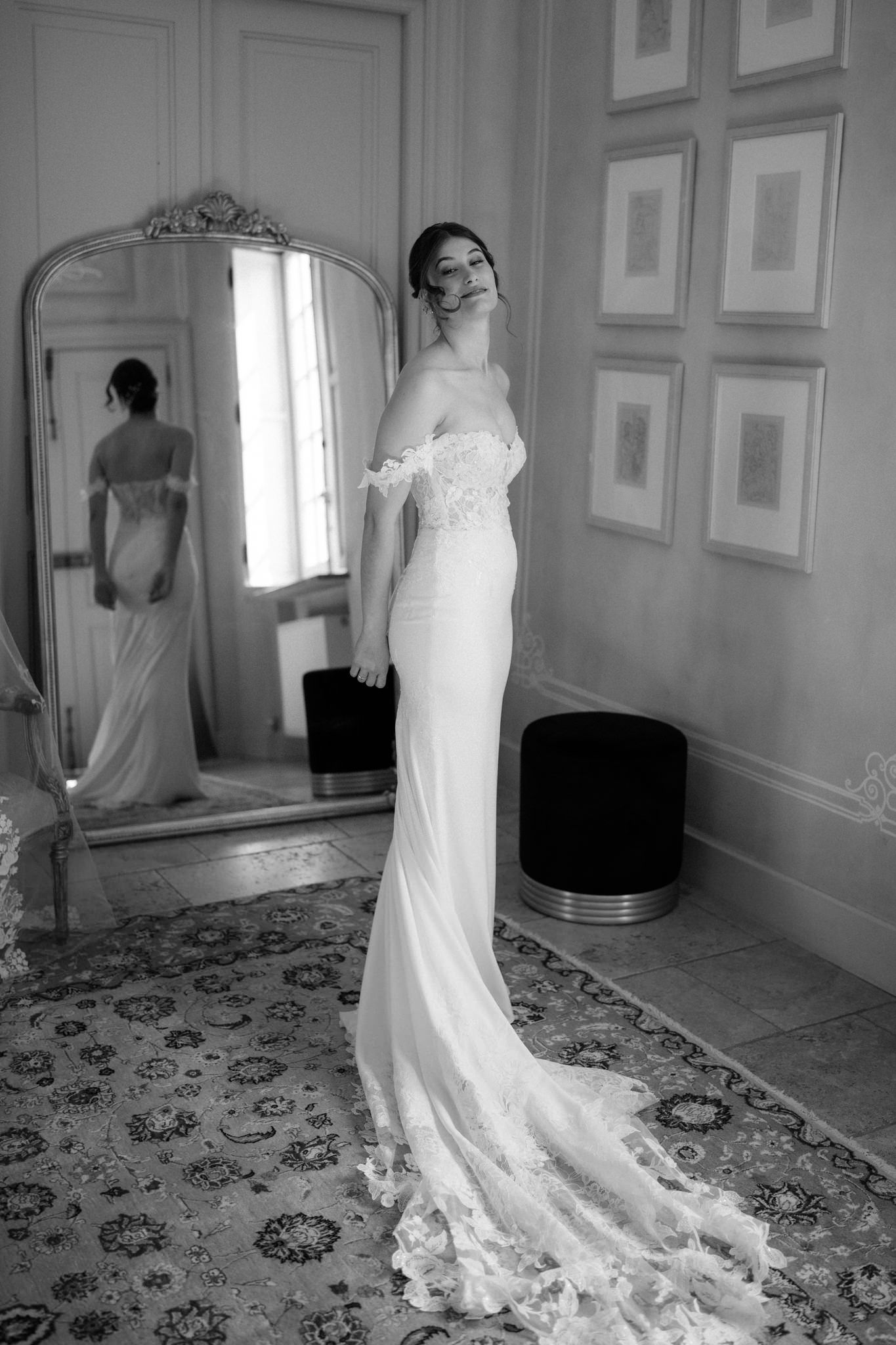 Elegant white wedding dress displayed in a classic room with ornate details.