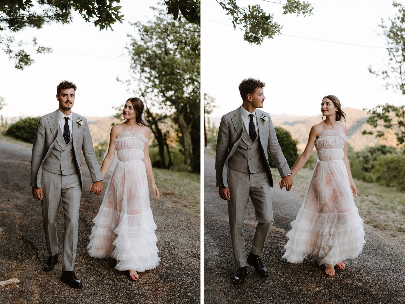 Wedding couple walking and laughing together on a mountain path in elegant attire.