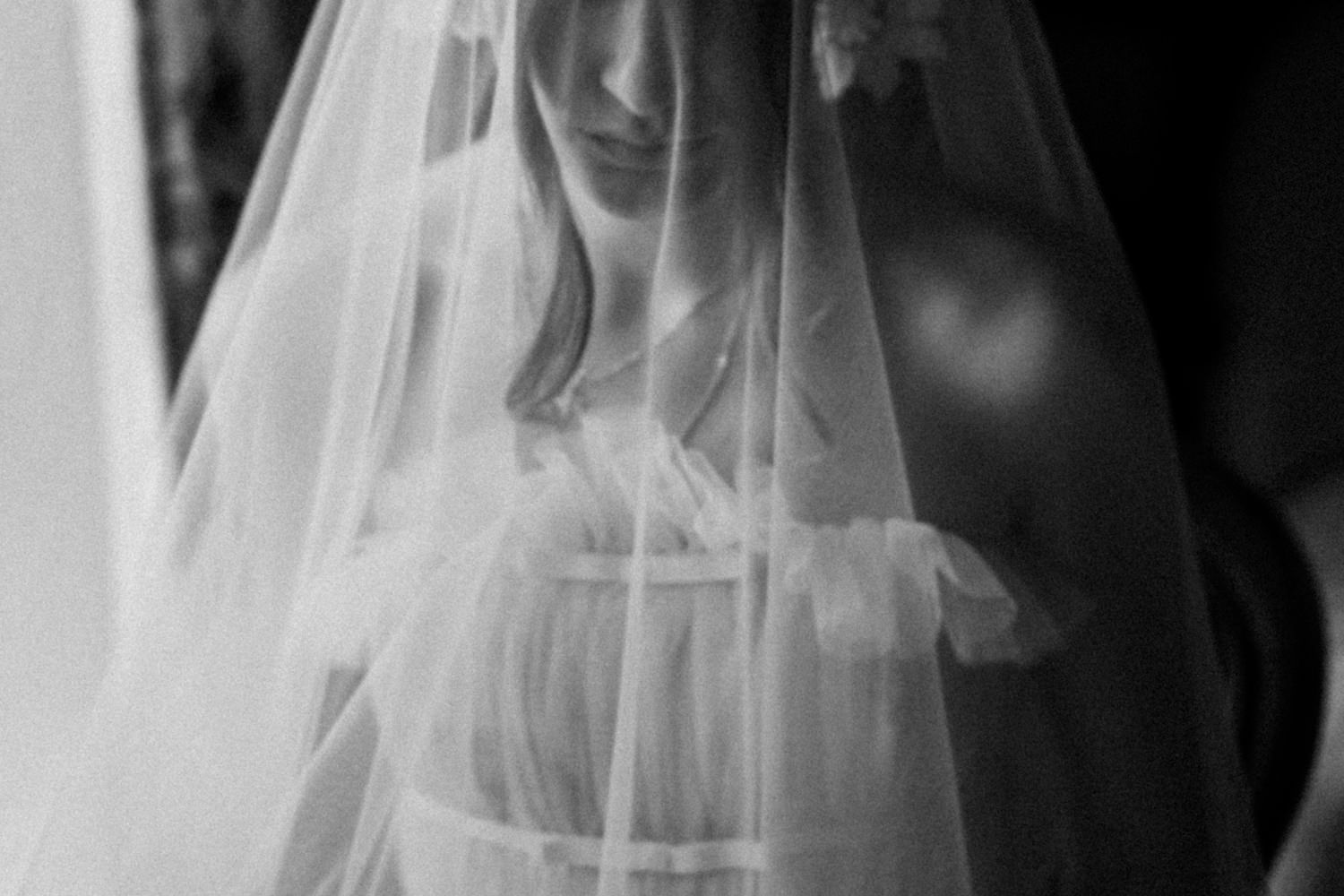 Ethereal black and white close-ups of flowing wedding veil details.