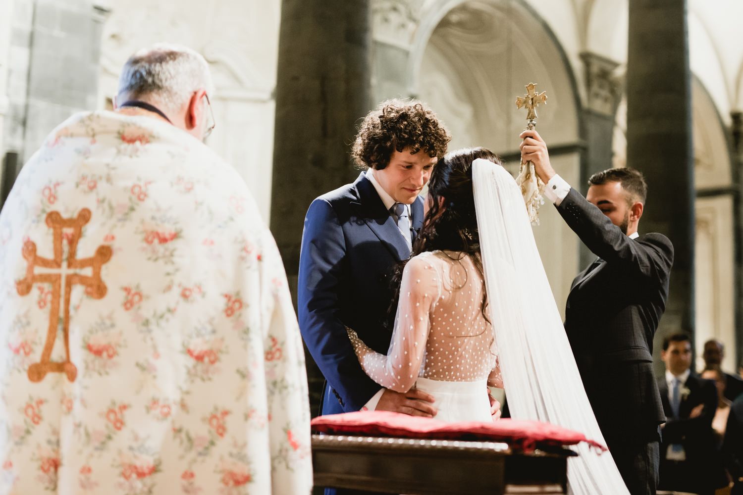 Traditional Catholic church ceremony with ornate architectural details and religious symbols.