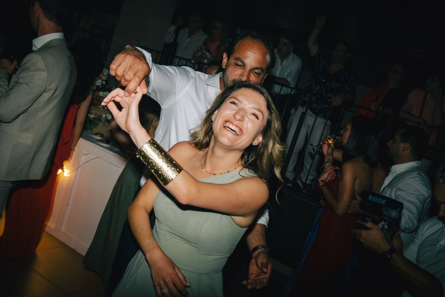 Lively dance floor moments captured during wedding reception celebrations.