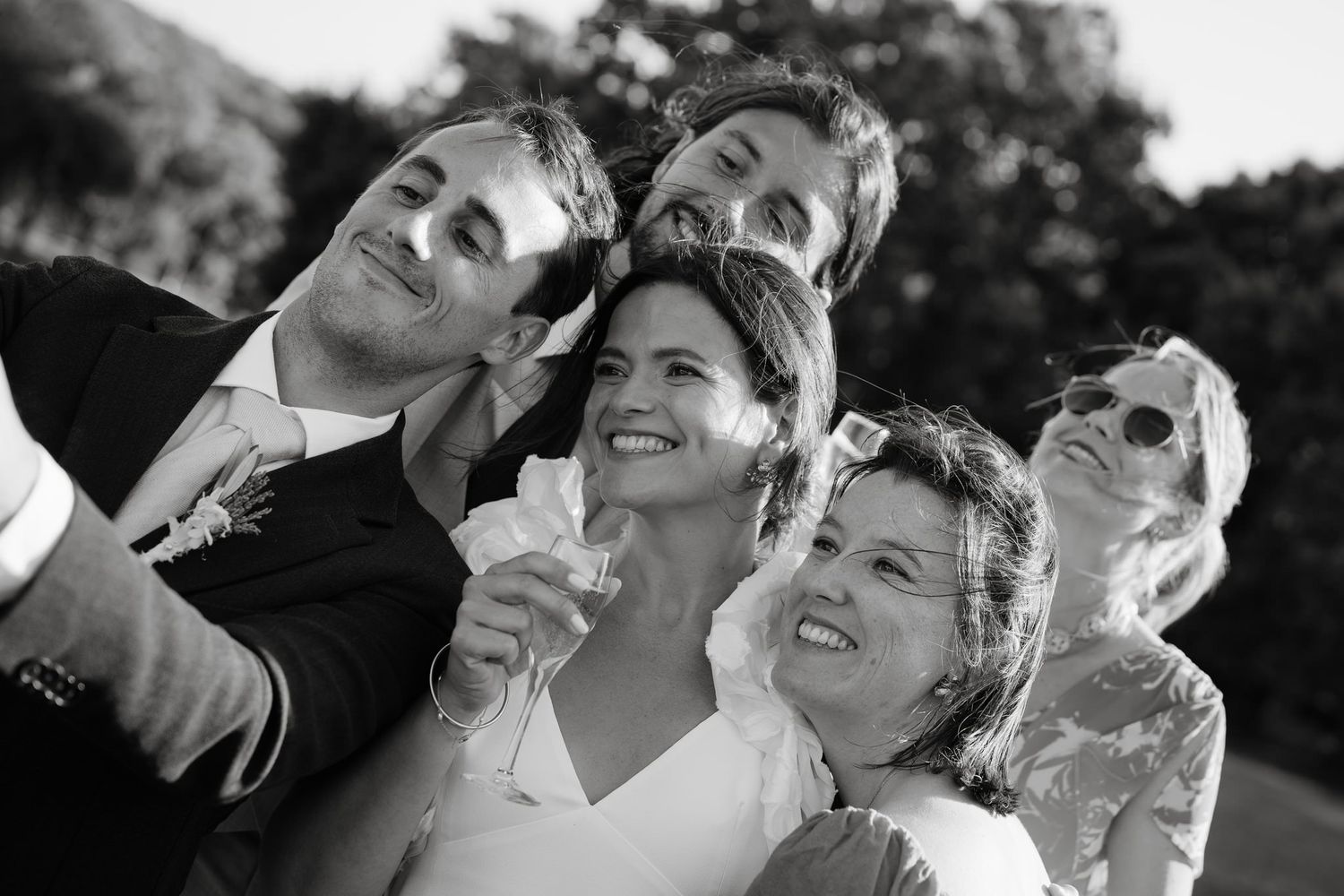 Series of black and white close-up shots showing joyful wedding party reactions.