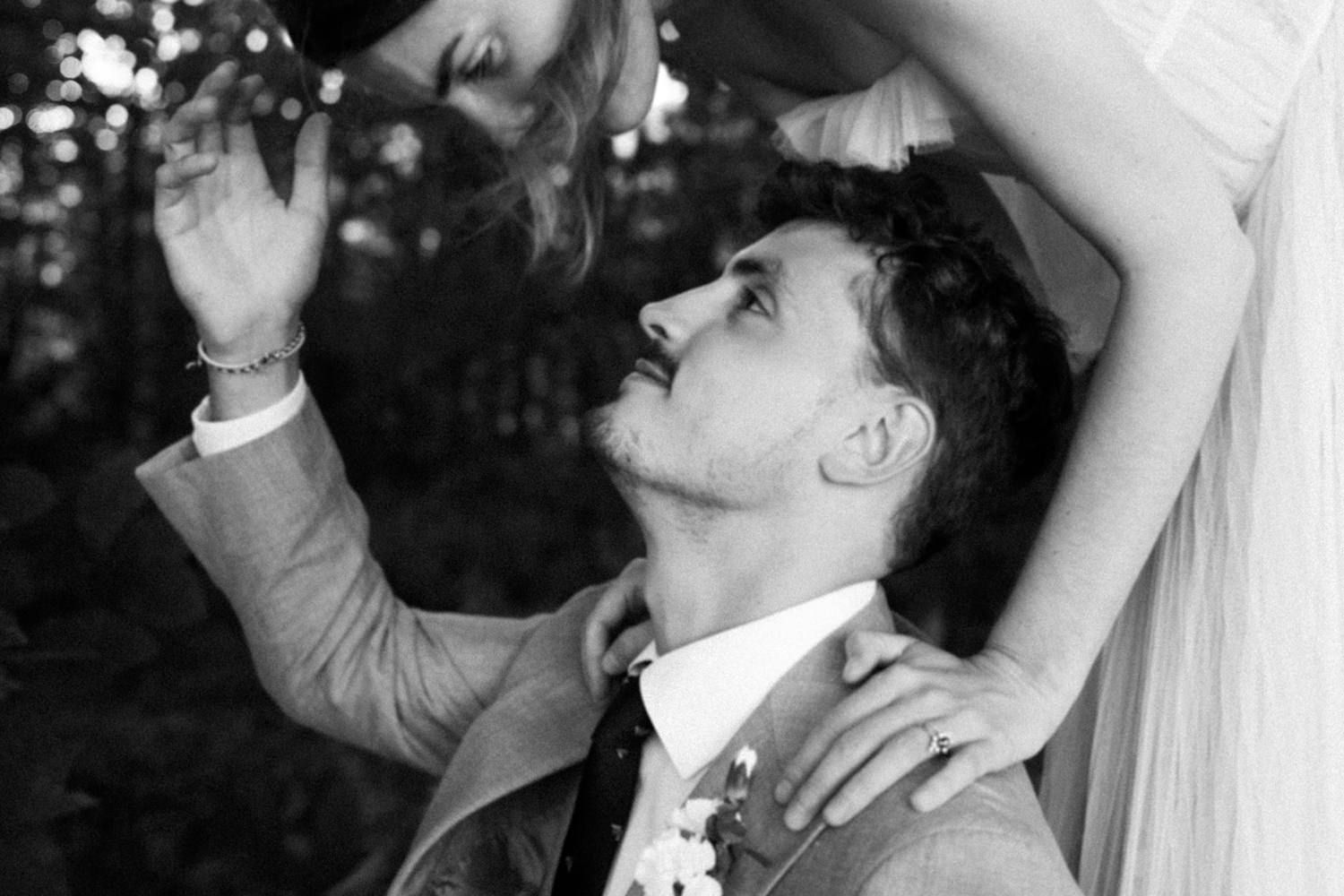 Artistic black and white wedding portrait capturing an intimate dance moment.