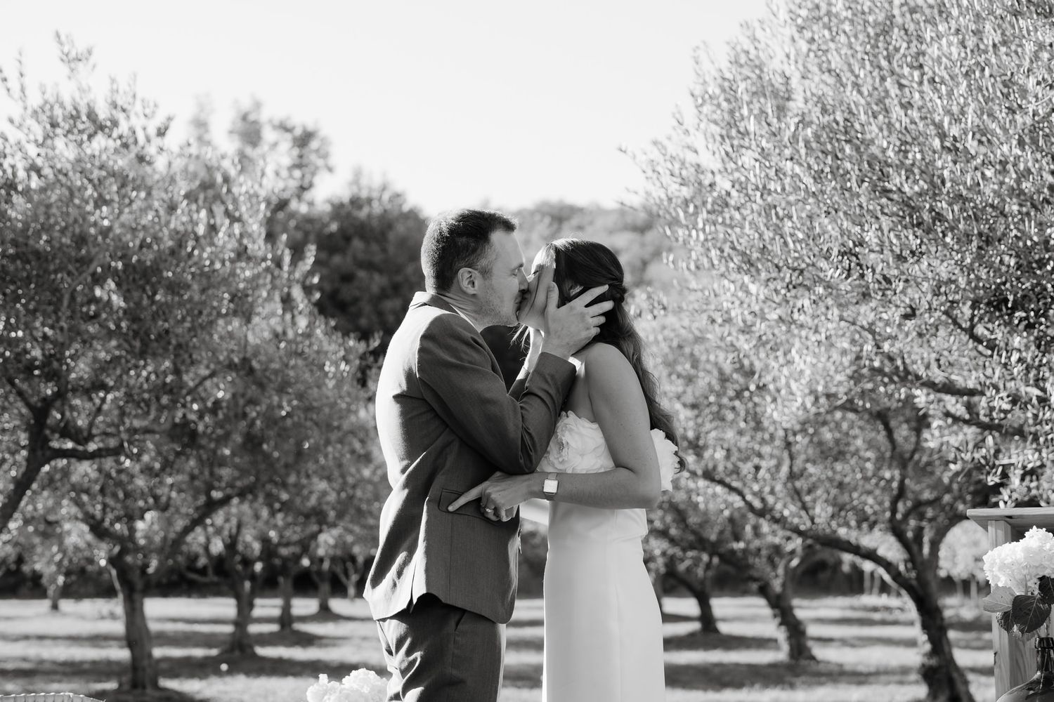 Black and white candid moments captured during an outdoor wedding ceremony.