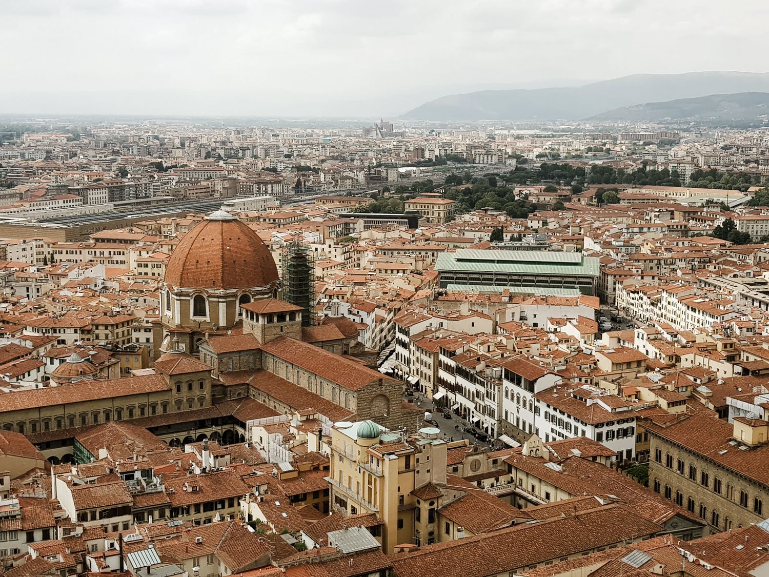 Panoramic view of Florence's historic city center with its iconic terracotta rooftops and domed cathedral.