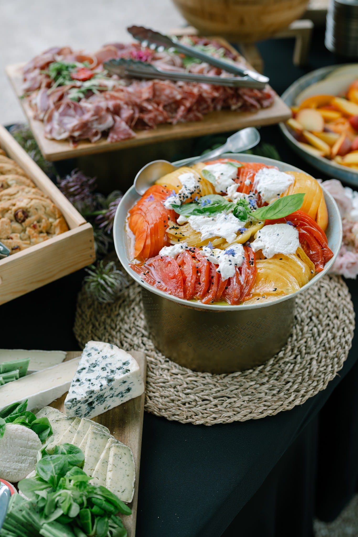 Elegant charcuterie and appetizer spread with colorful meats, cheeses and garnishes.