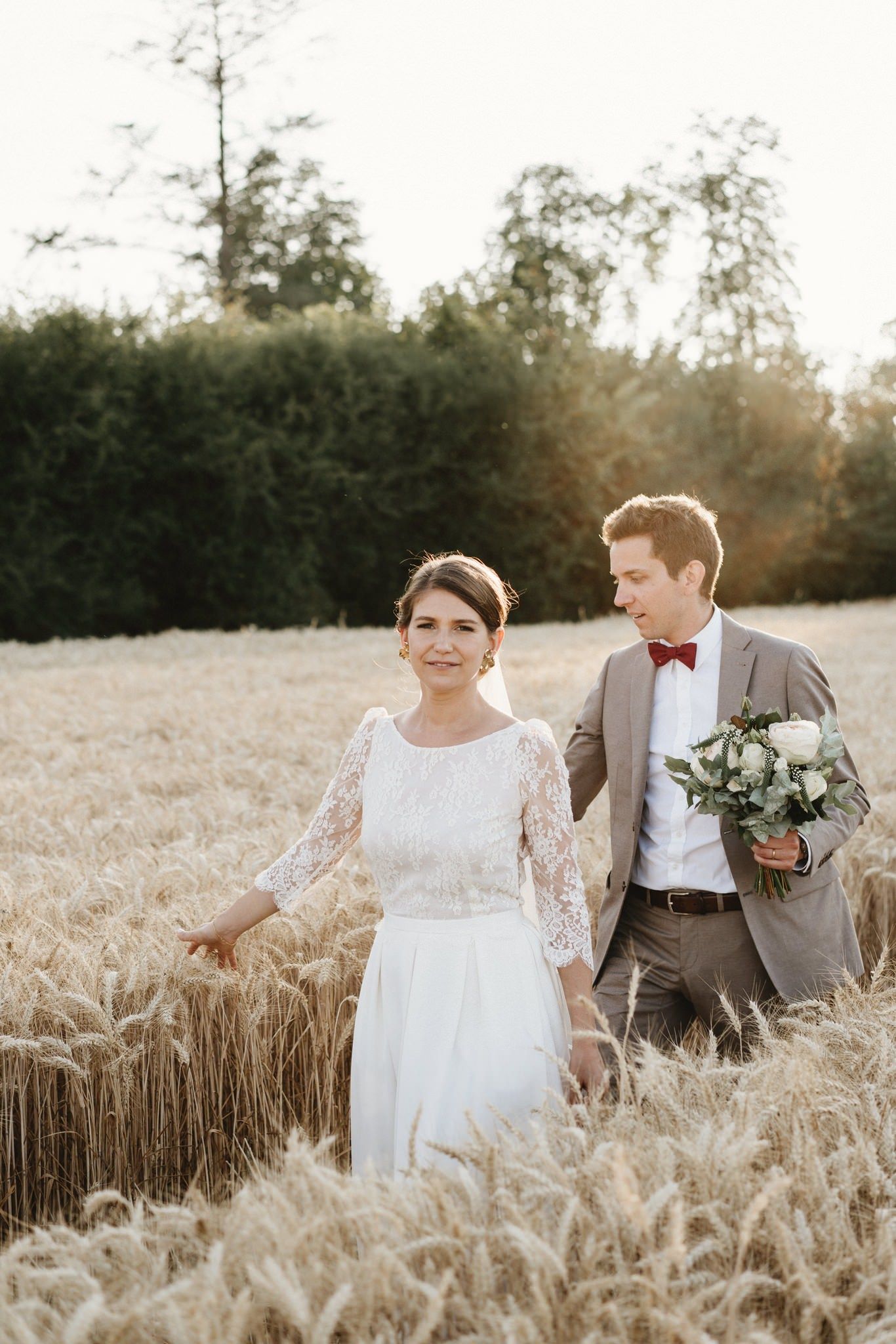 A romantic photo shoot in a golden wheat field at sunset.