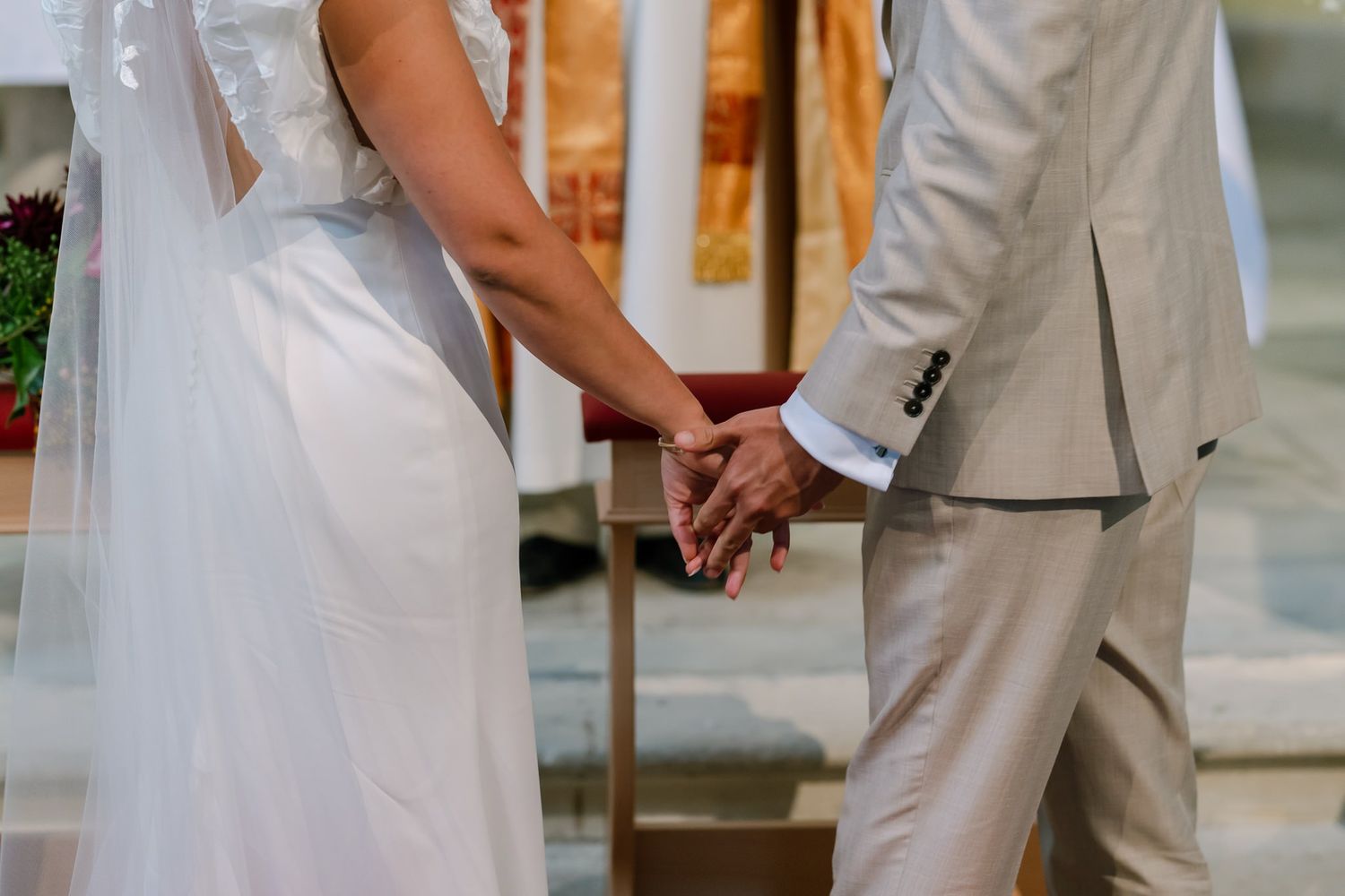 Bride and groom exchanging vows at the altar during their traditional church ceremony.