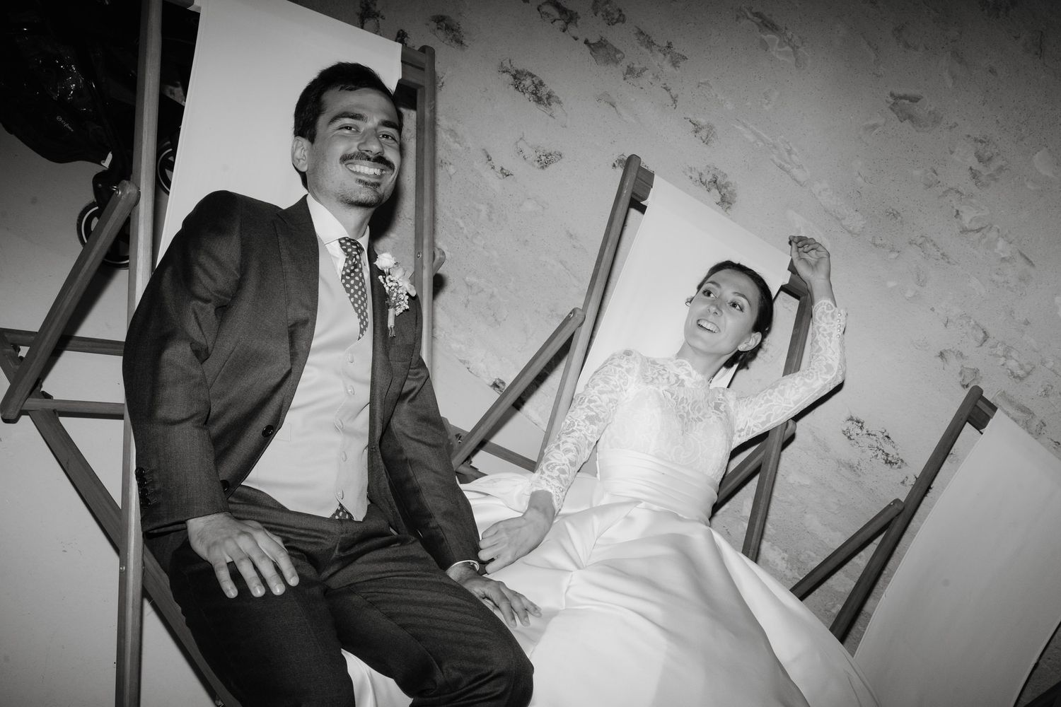 Wedding celebration captured in black and white showing dancing and laughter.