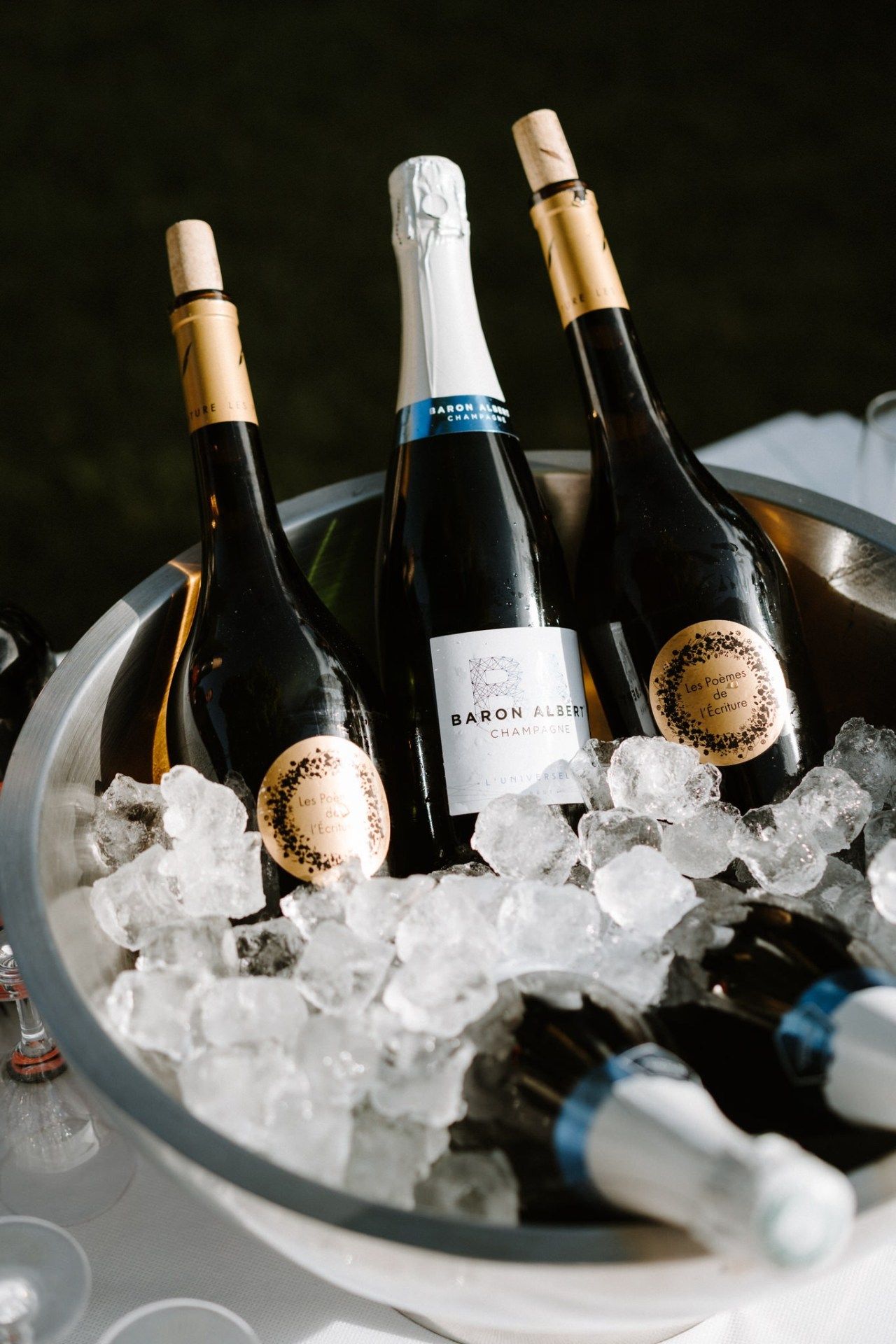 Champagne bottles chilling in ice bucket at wedding reception.