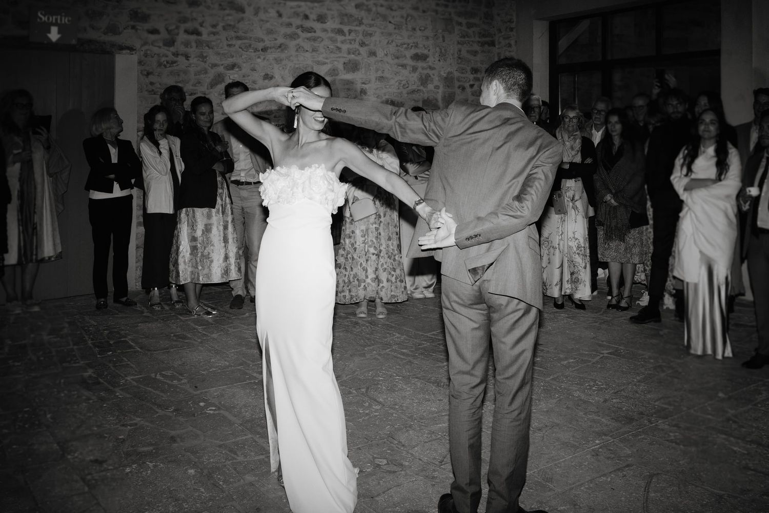 Black and white photos show couples dancing at a wedding reception in an indoor venue.