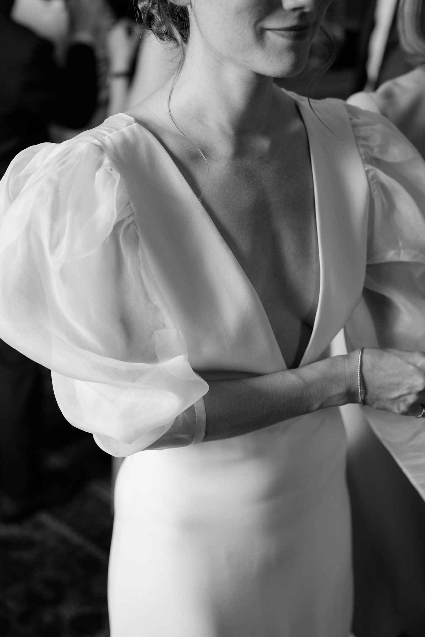Close-up shots of a bride in a white dress with puffy sleeves getting ready for her wedding day.
