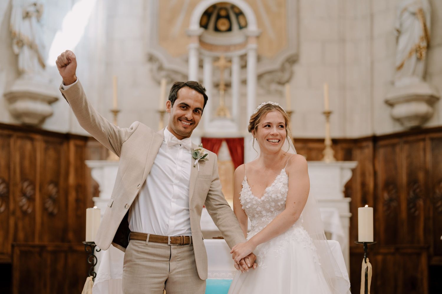Joyful celebration during wedding ceremony in historic church sanctuary.