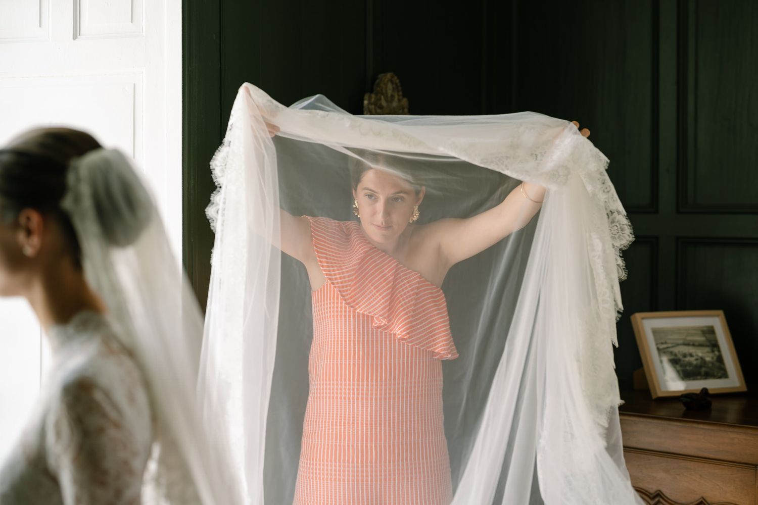 Wedding preparation sequence showing someone adjusting a bridal veil in natural light.