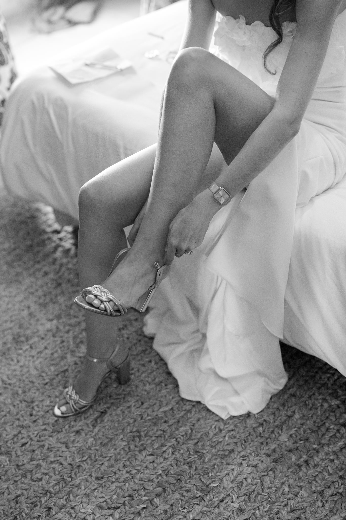 Black and white photo of sparkly bridal shoes being put on before the ceremony.