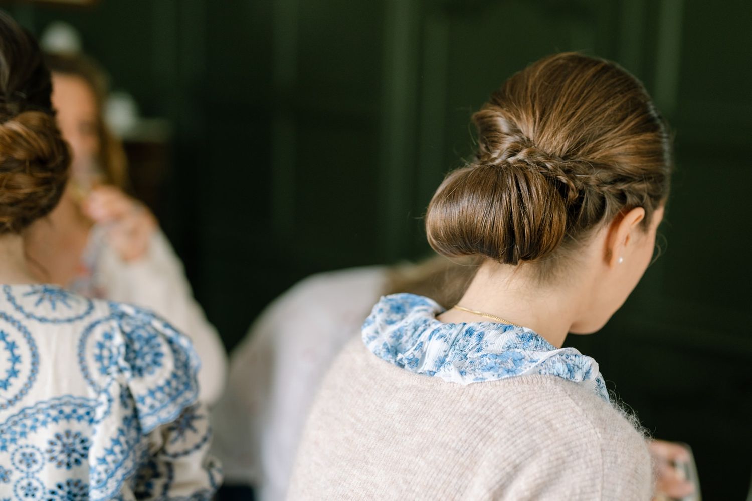 Back view of someone wearing a blue and white floral dress with an elegant updo hairstyle.