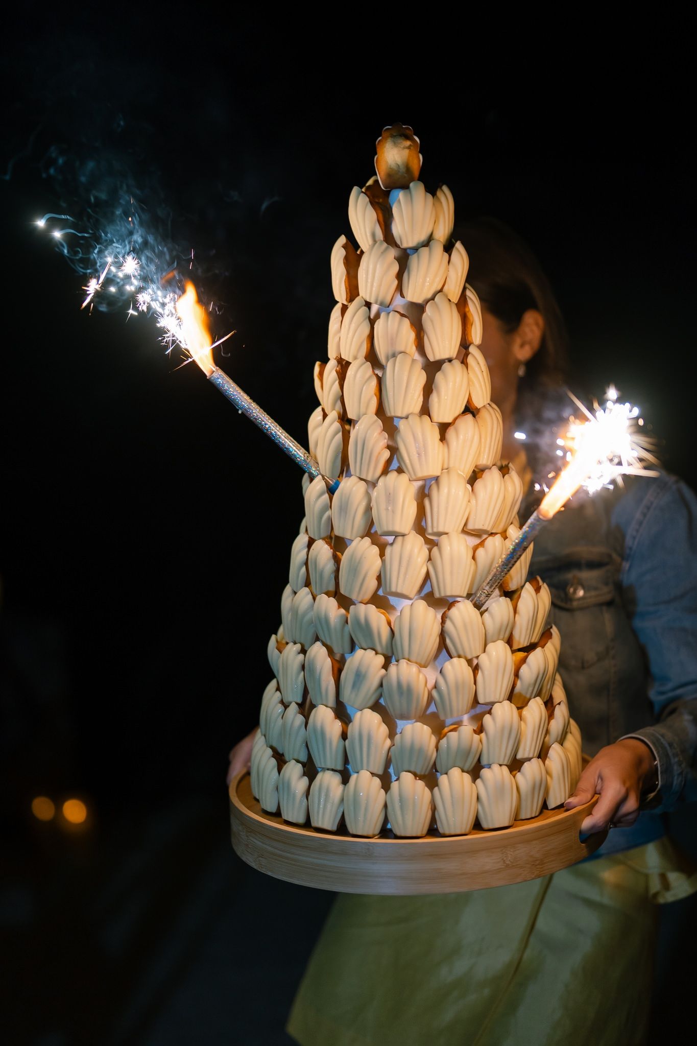 A tower of macarons decorated with sparklers creates a dramatic dessert display.
