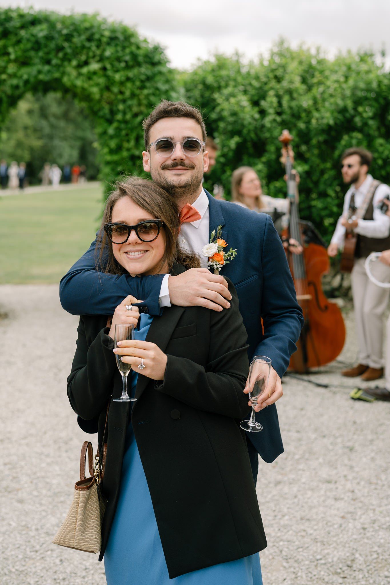 Wedding guests enjoying cocktails at an outdoor reception.