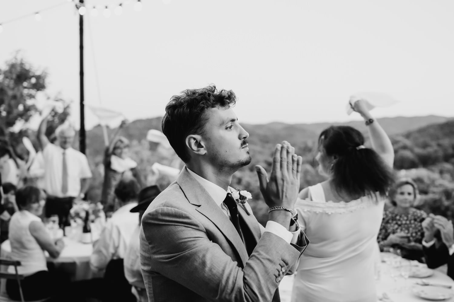 Wedding guests enjoying themselves during outdoor celebration.