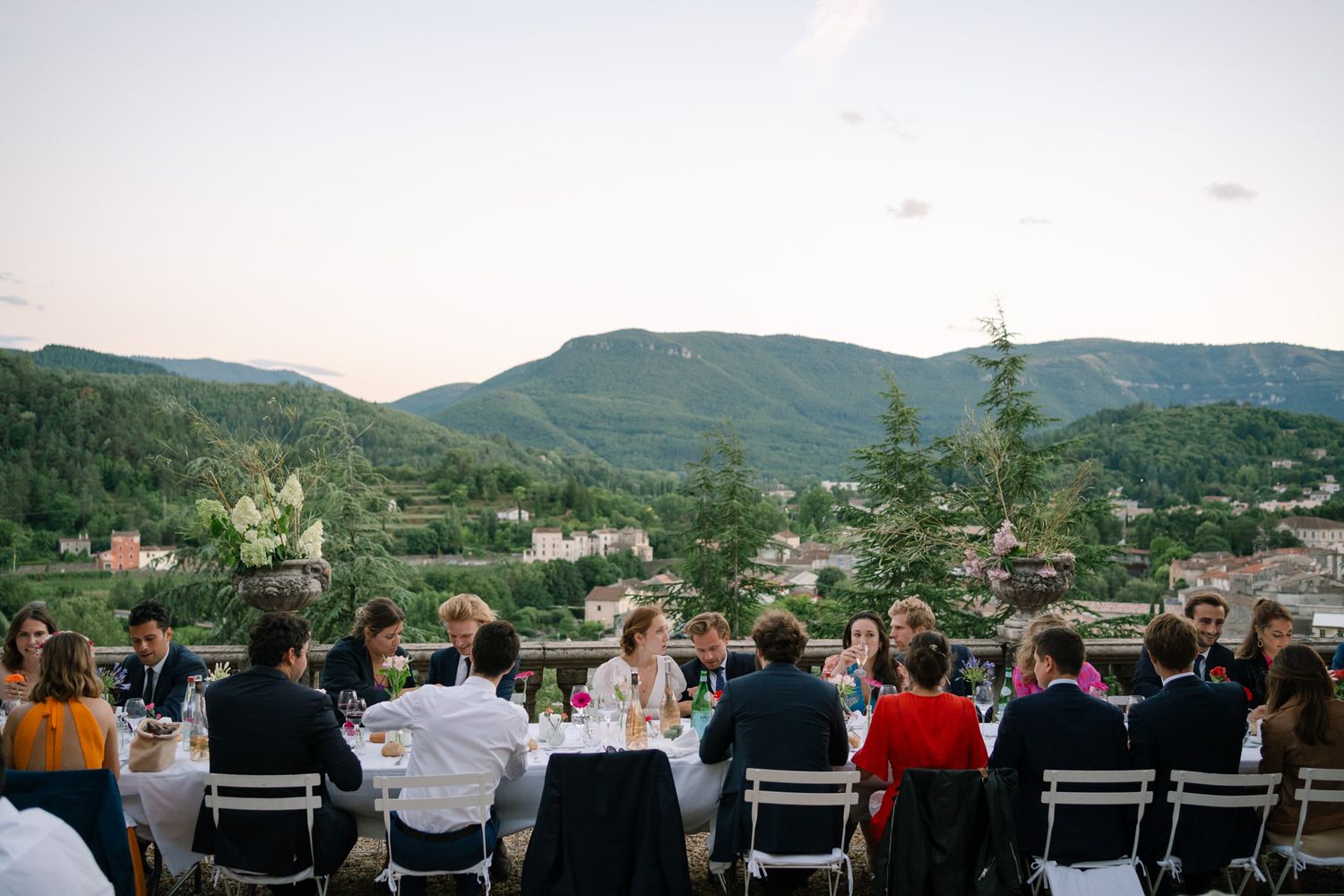 Panoramic view of wedding reception setup with mountain landscape in the background.