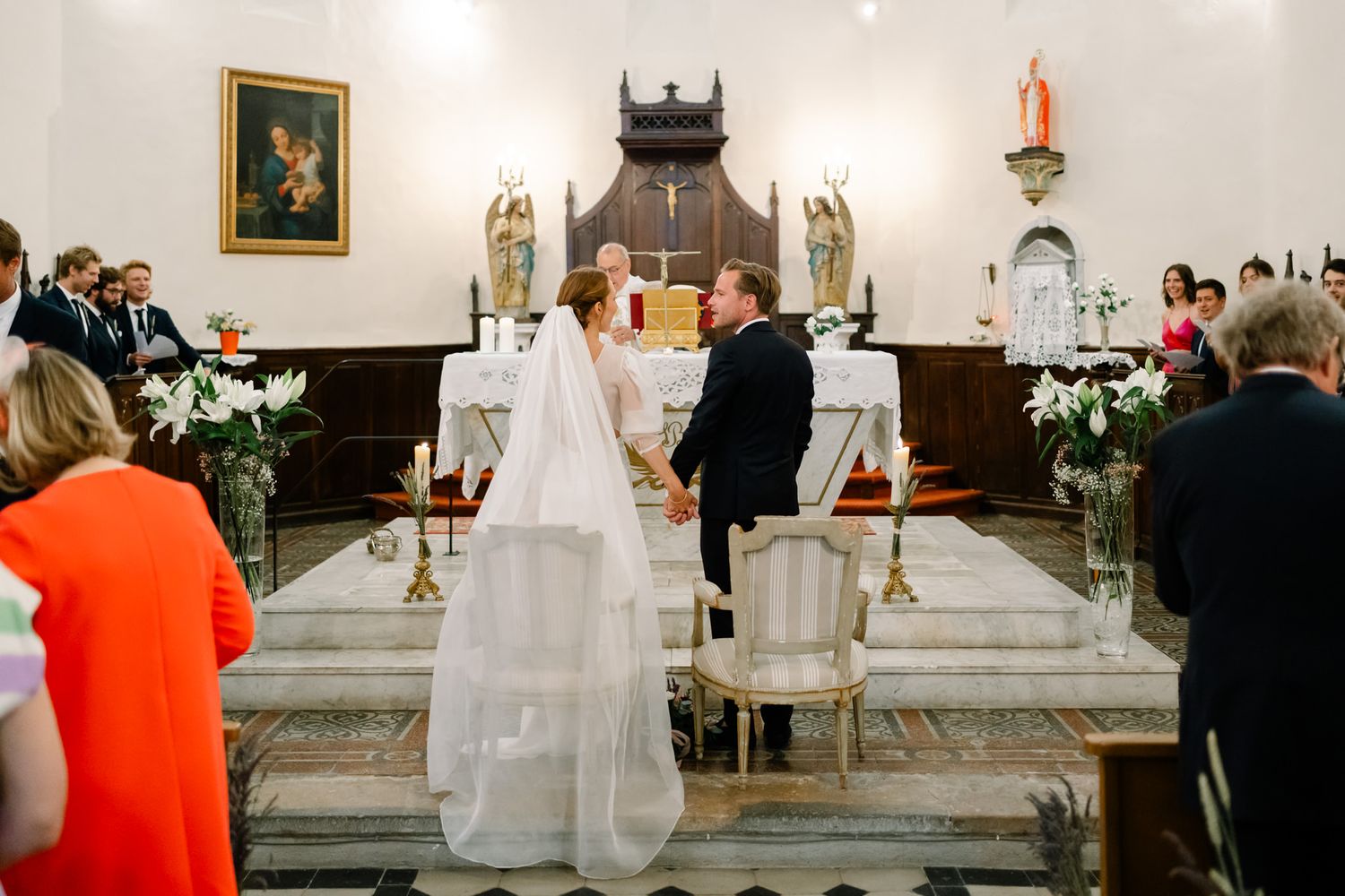 Traditional church wedding ceremony with altar decorations and gathered congregation.