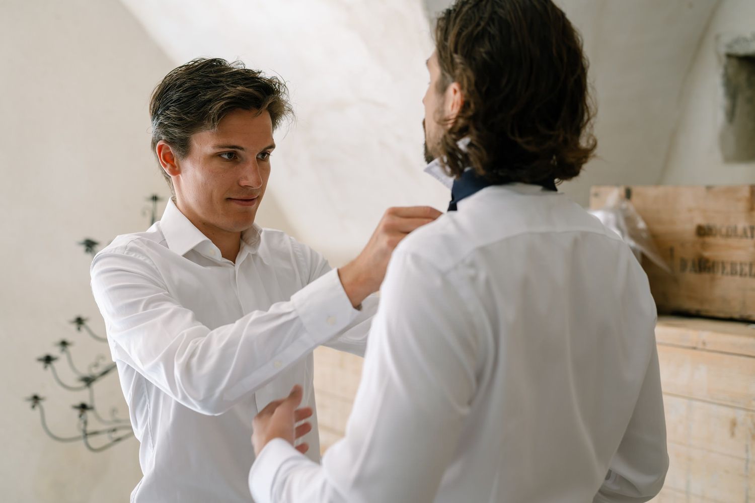 People in formal white shirts gathered in casual conversation.