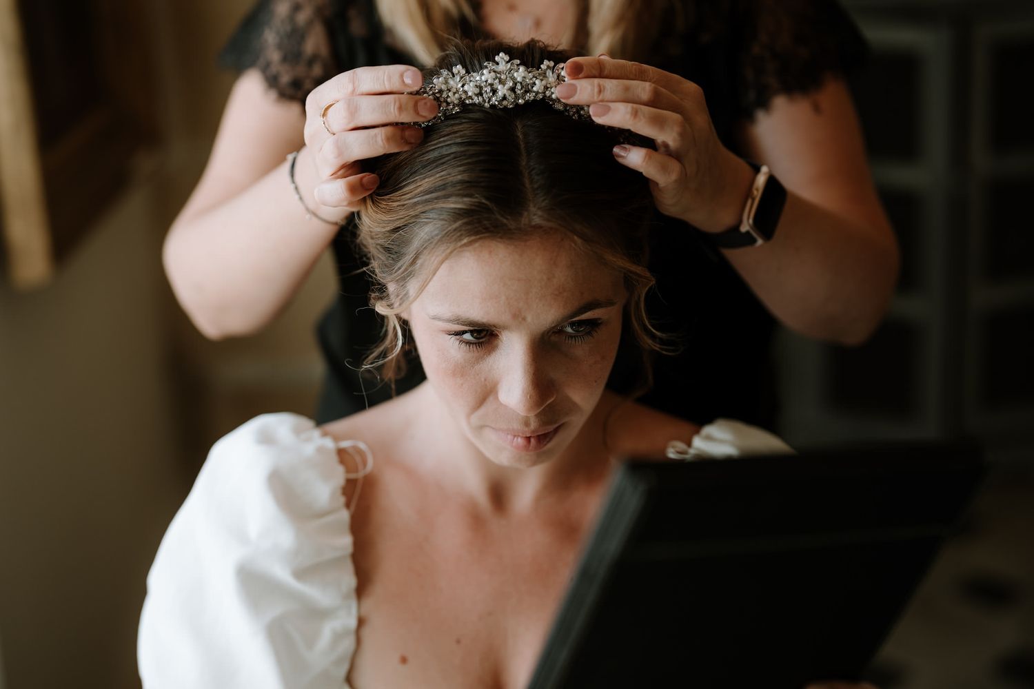 Close-up shots of wedding day preparations in a dimly lit room.