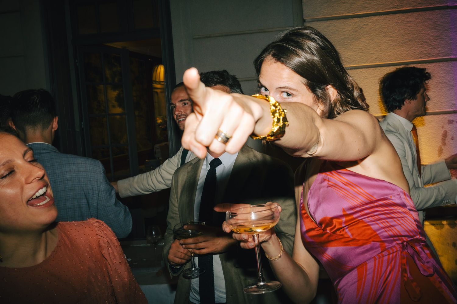 People dancing and having fun at a lively wedding reception party.