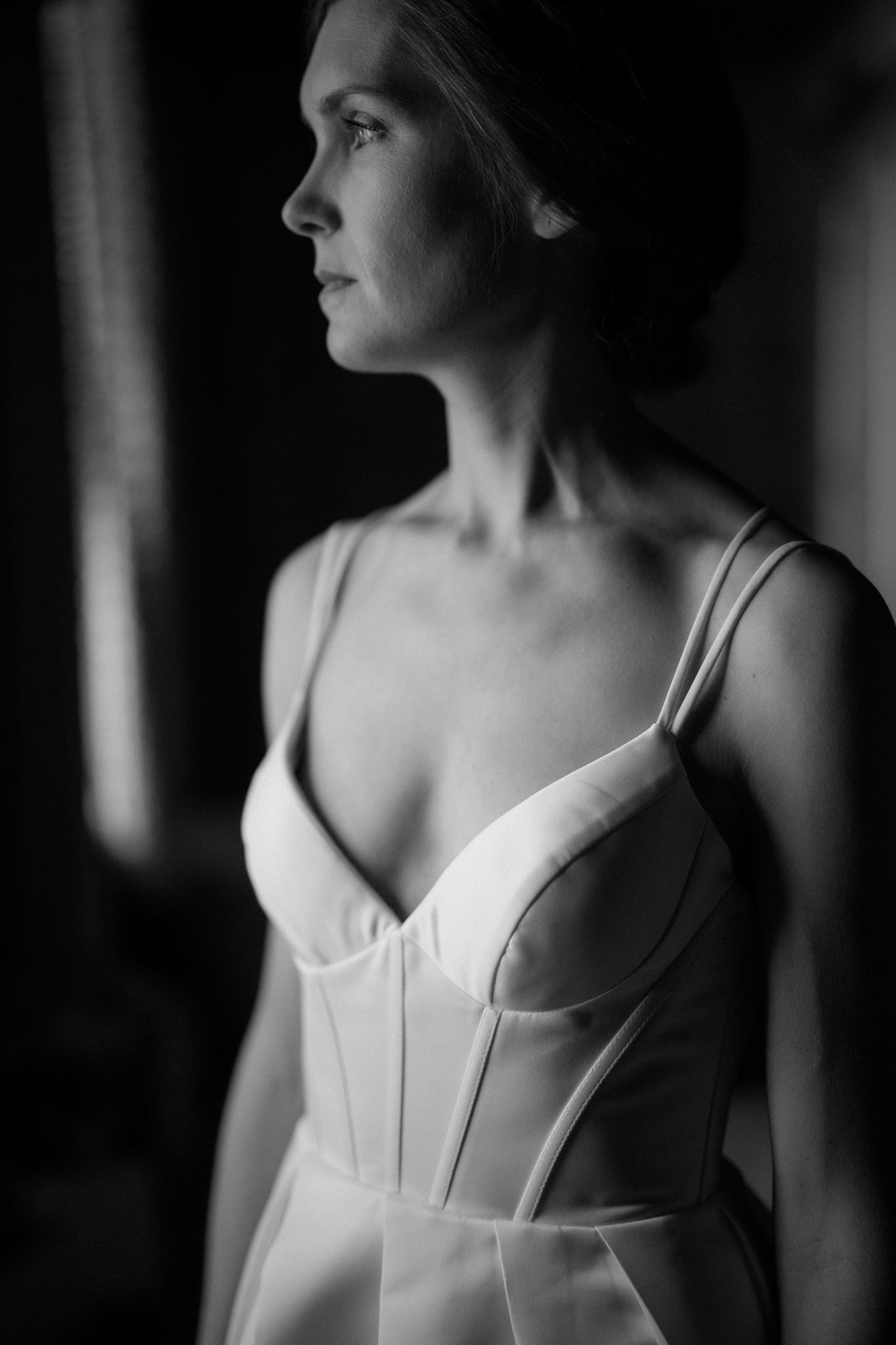 Artistic black and white portrait showing elegant white bridal corset.