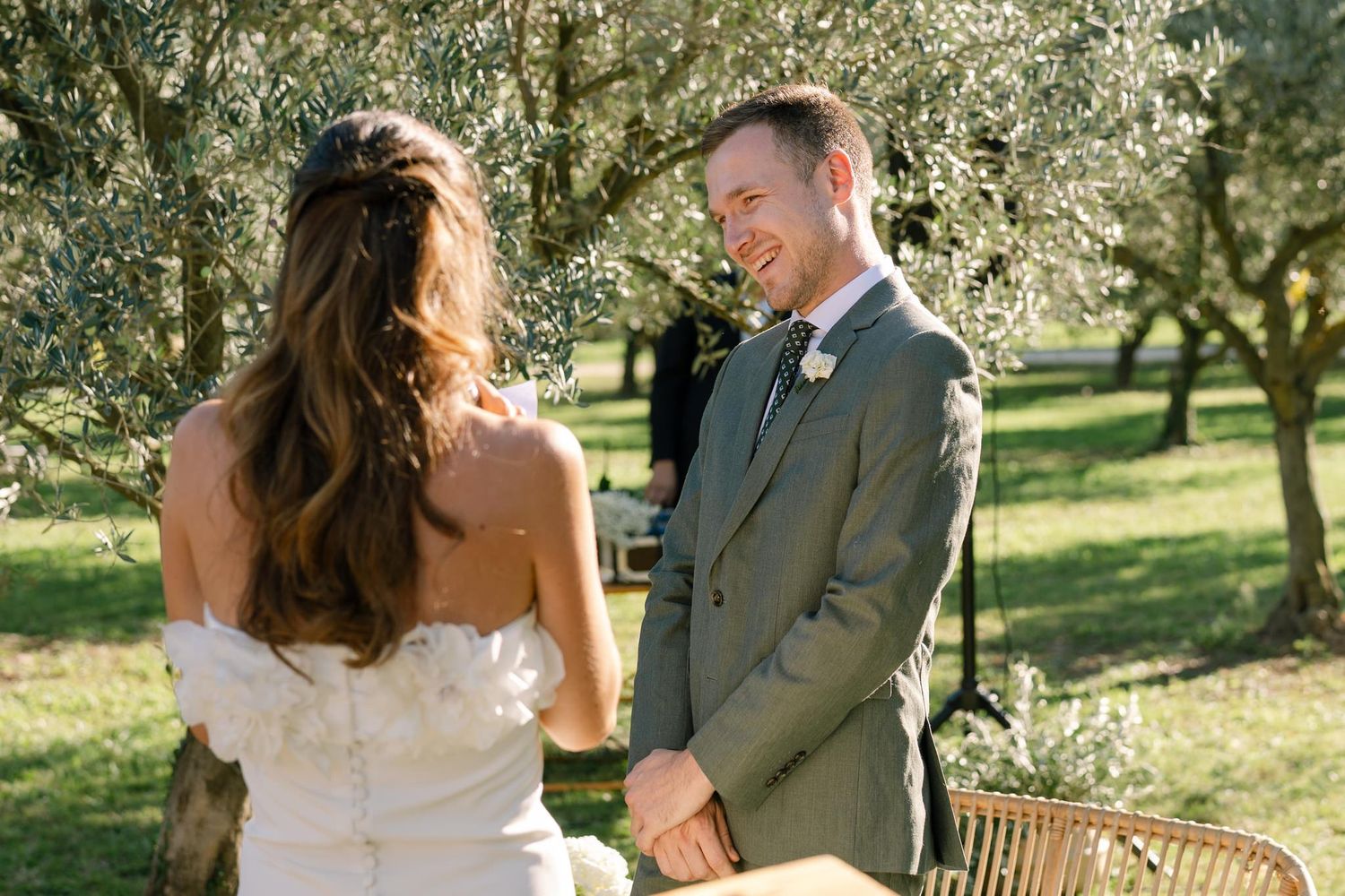 Romantic moments captured between newlyweds in a sunlit olive grove setting.