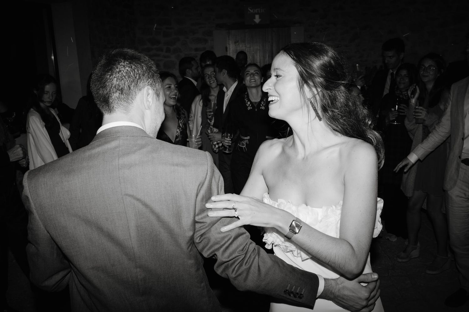 Couples dancing intimately at a wedding reception shown in monochrome photography.