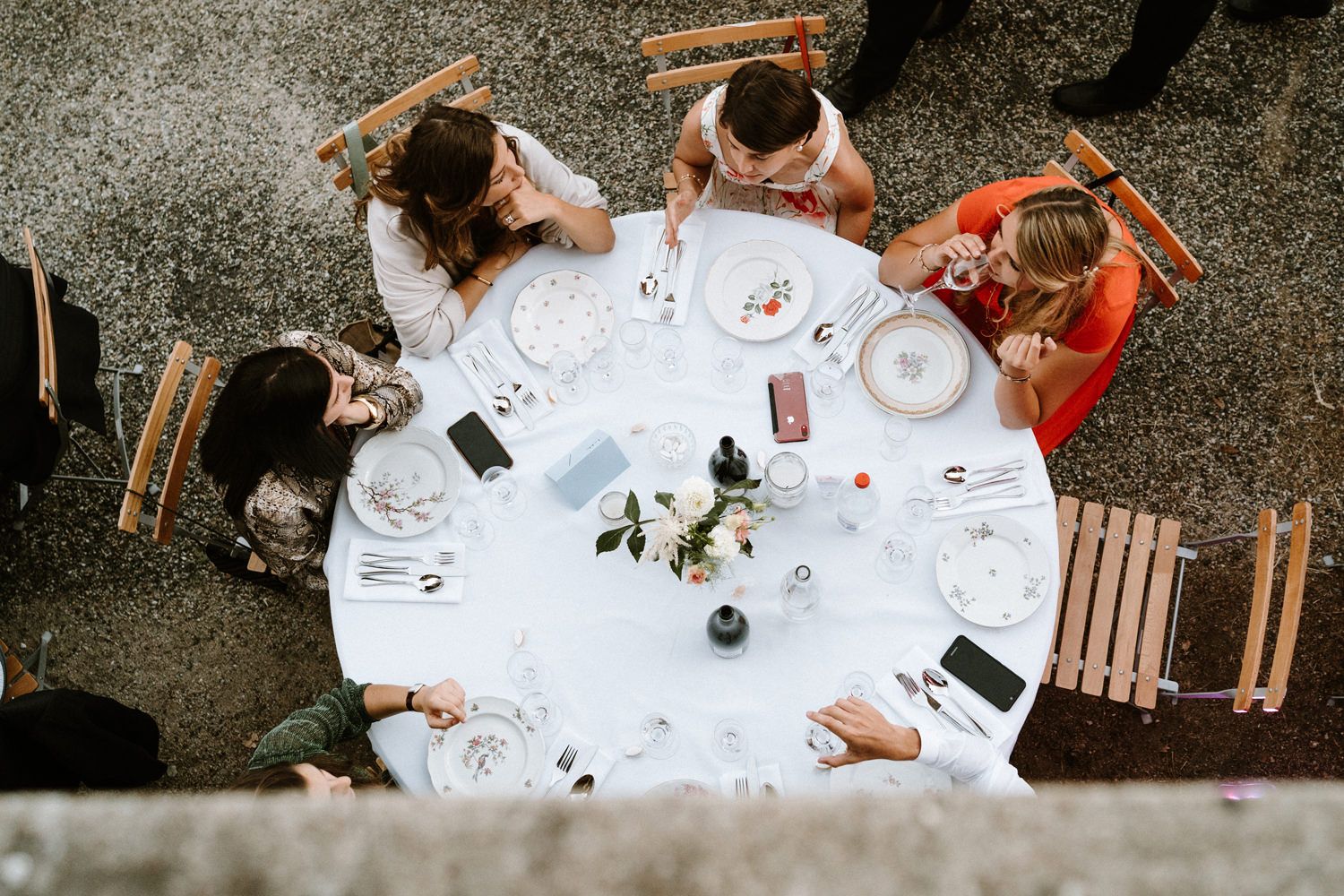 Overhead view of wedding reception tables with guests socializing.