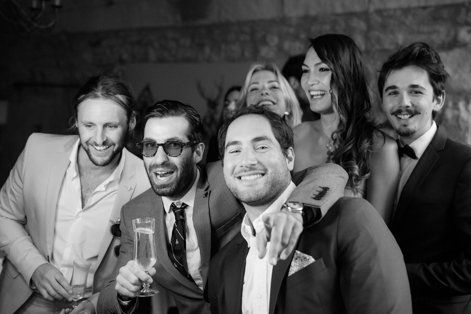 Group celebrating with drinks at an elegant black and white reception.