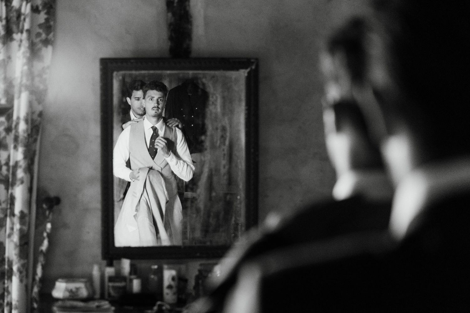 Black and white wedding photography showing intimate moments during preparation.