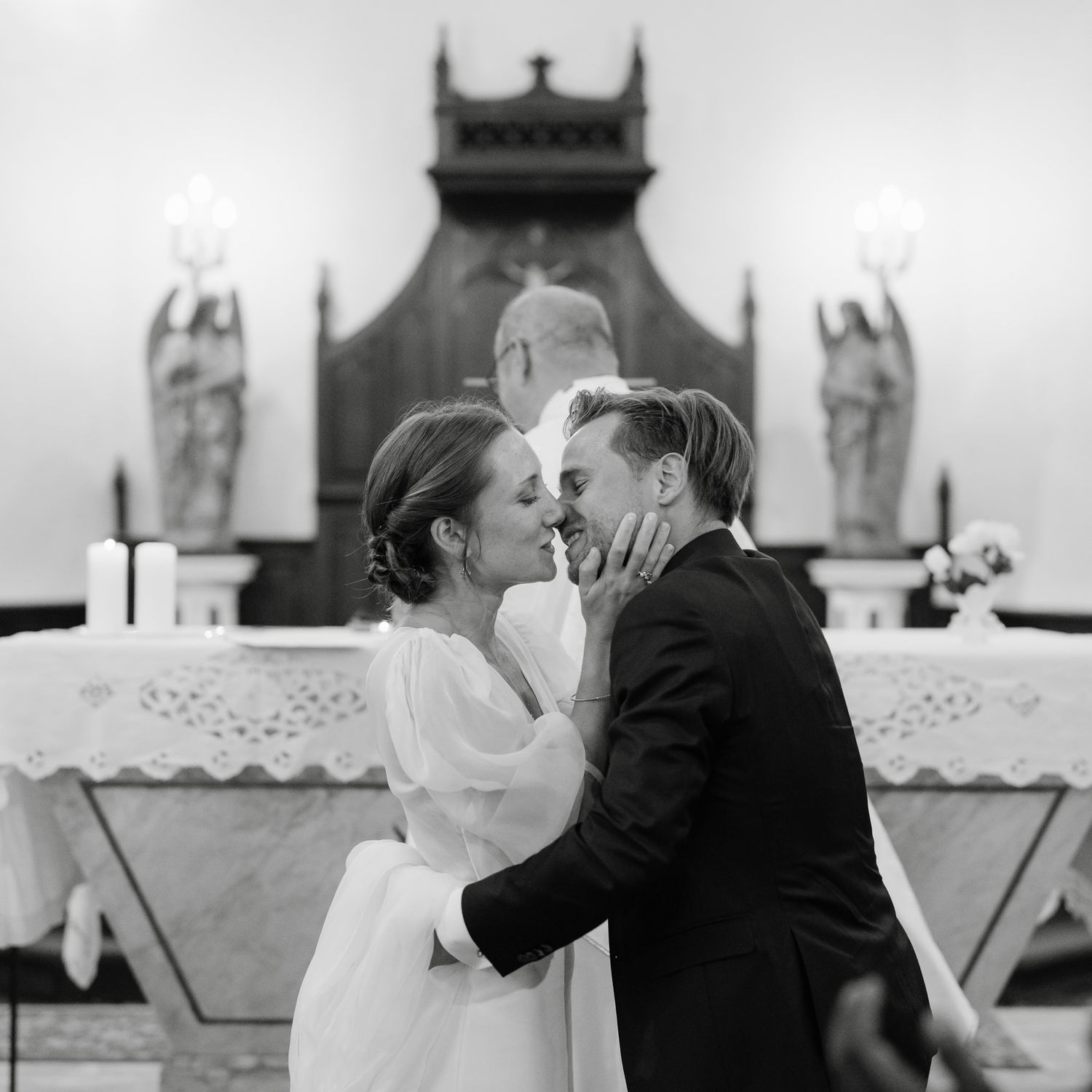 Black and white photo sequence showing romantic wedding ceremony moments in a church.