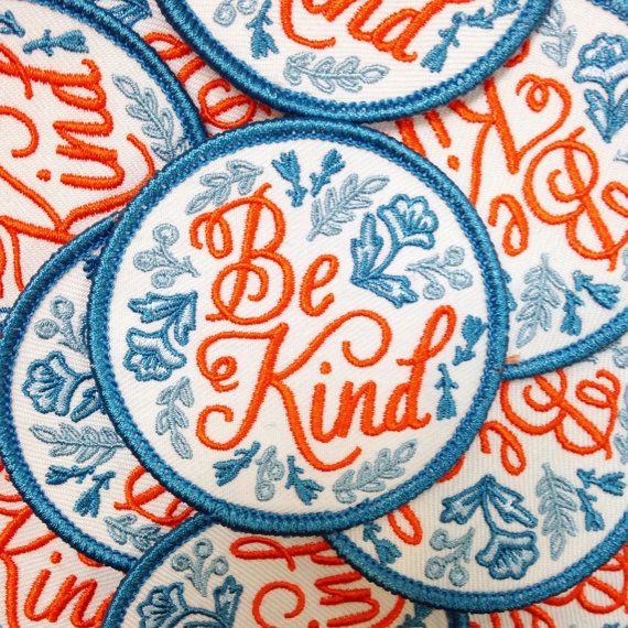 Pattern of blue and orange circular vintage Coca-Cola patches or badges.