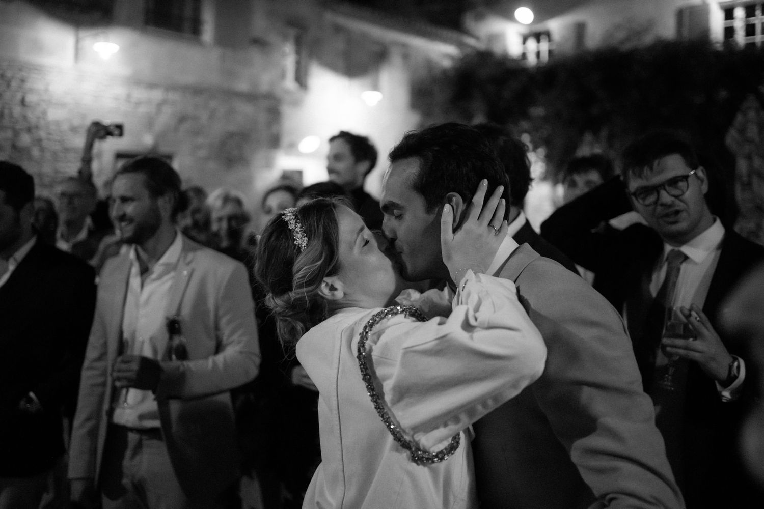 Black and white photos show guests dancing and celebrating at an elegant indoor reception.