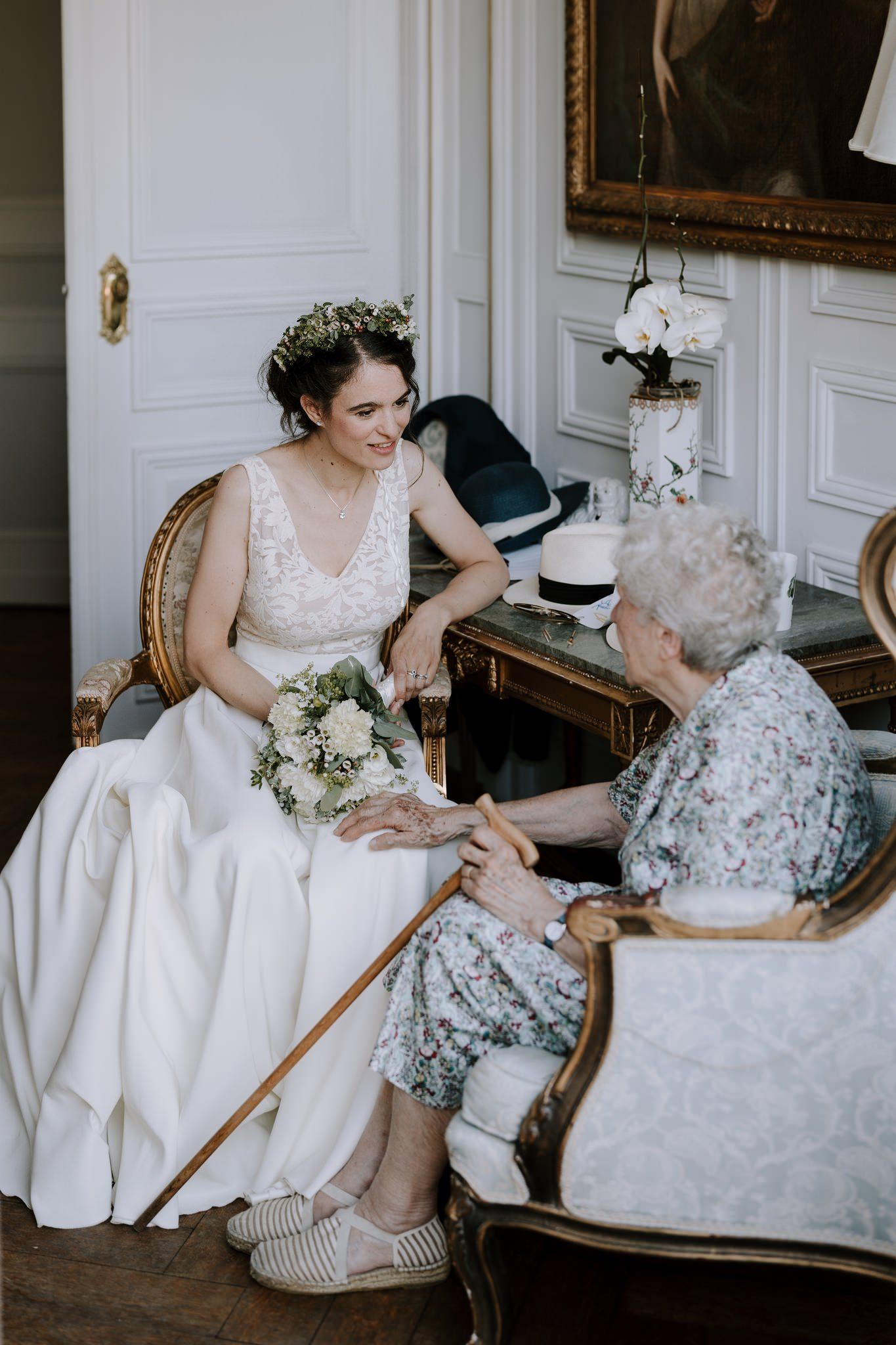 Intimate moment captured in an elegant white room with traditional furnishings.
