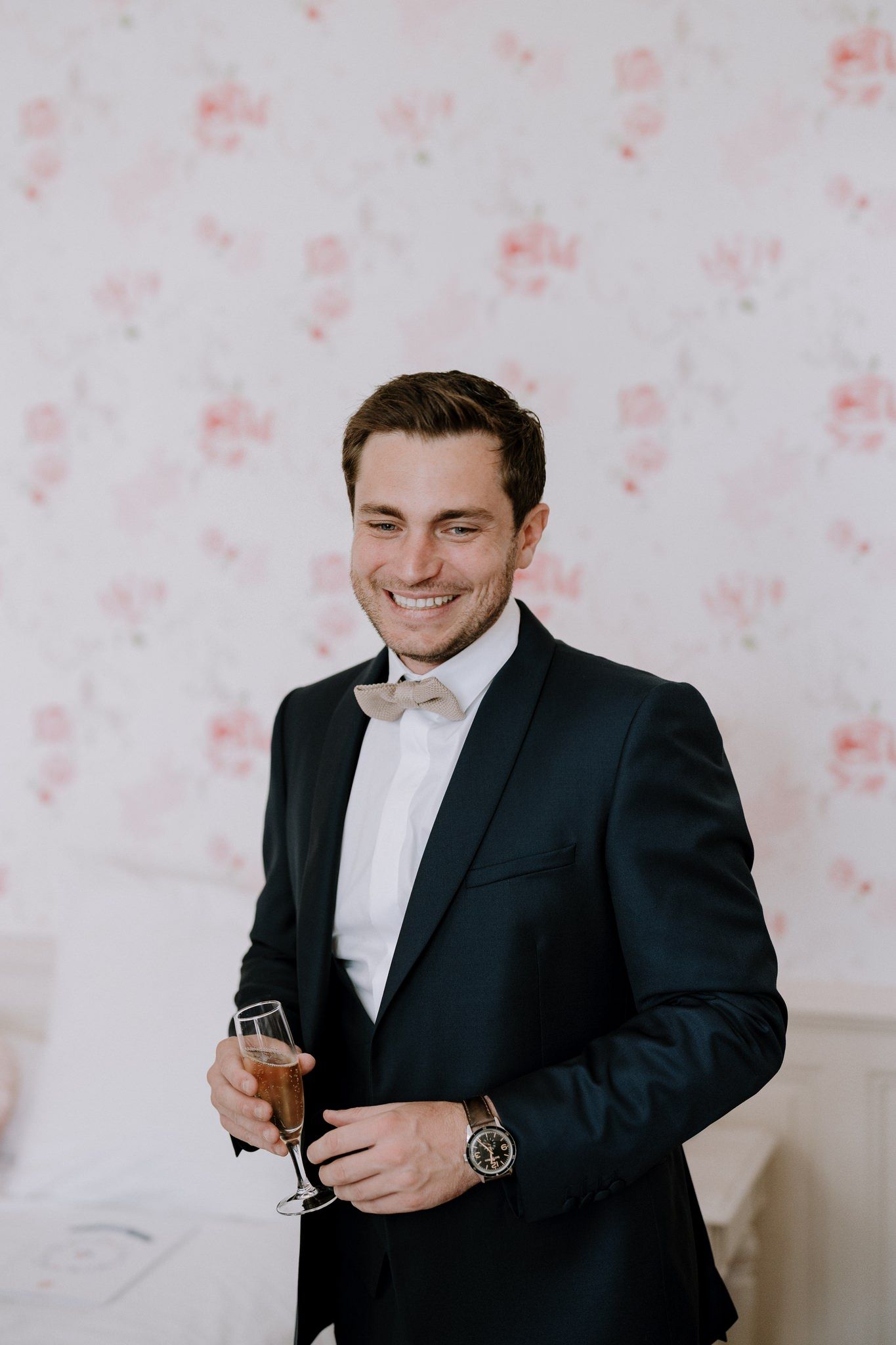 Someone in formal attire adjusting cufflinks while getting ready.