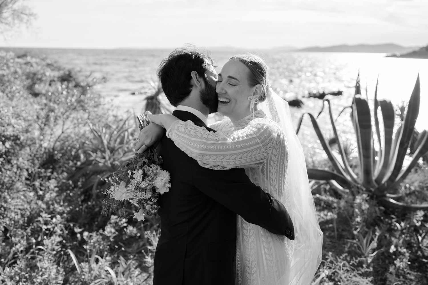 Black and white wedding portraits captured in a coastal garden setting with natural light.