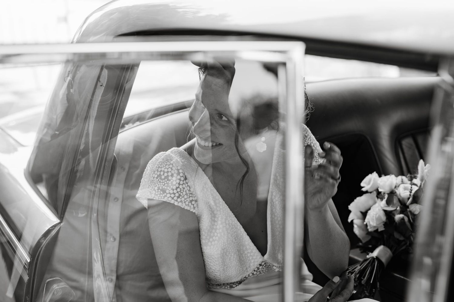 Black and white wedding photos showing tender moments in a car.