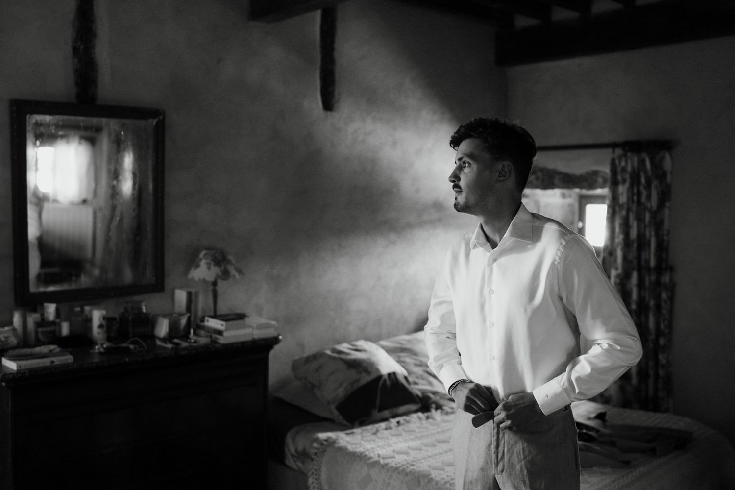 Atmospheric black and white interior scenes with dramatic lighting.