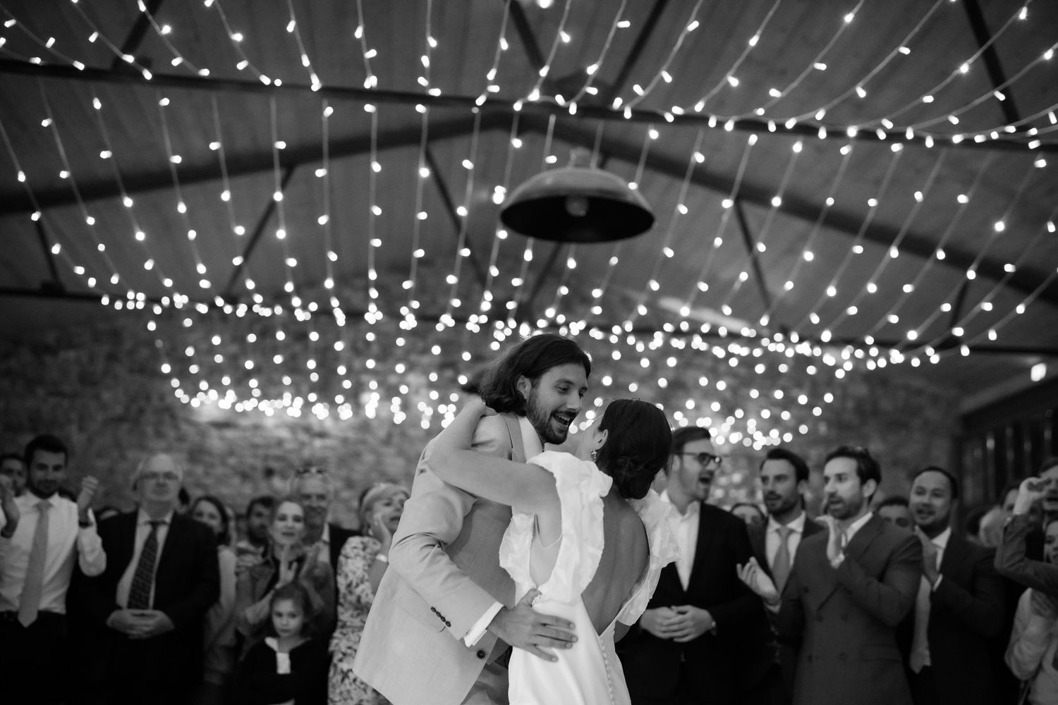 String lights create a magical canopy over a wedding reception venue.