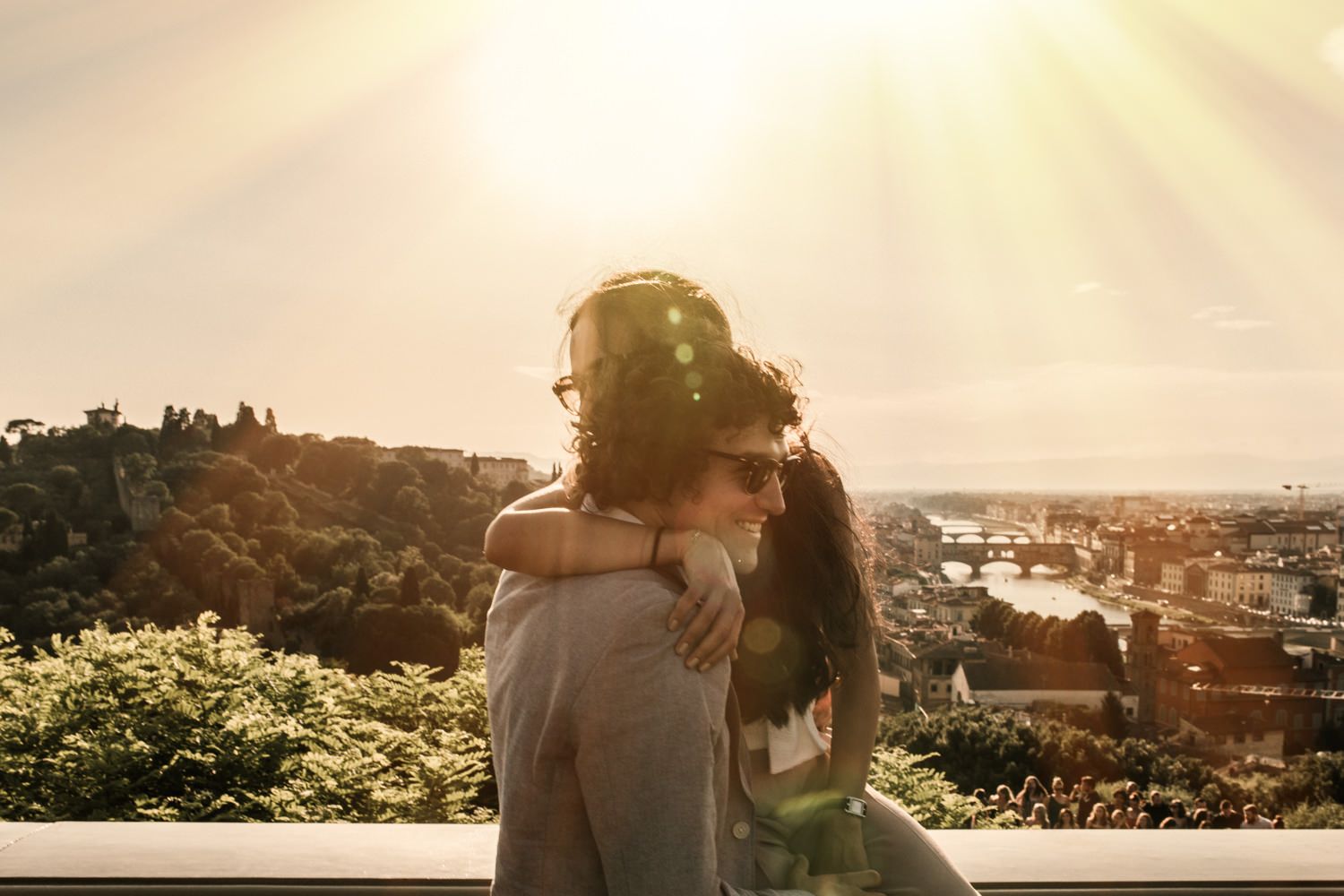 Romantic sunset moment overlooking a European city skyline.