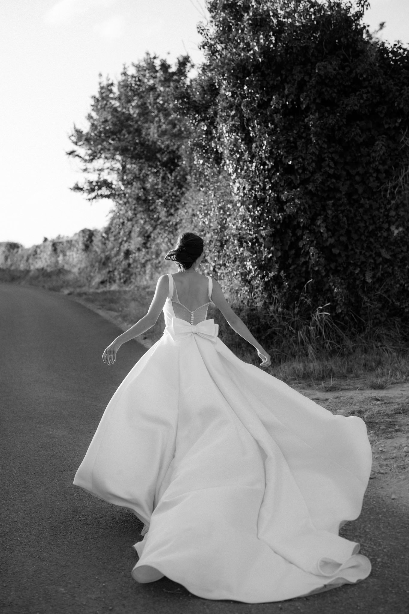Black and white photos of a flowing white wedding dress in motion.