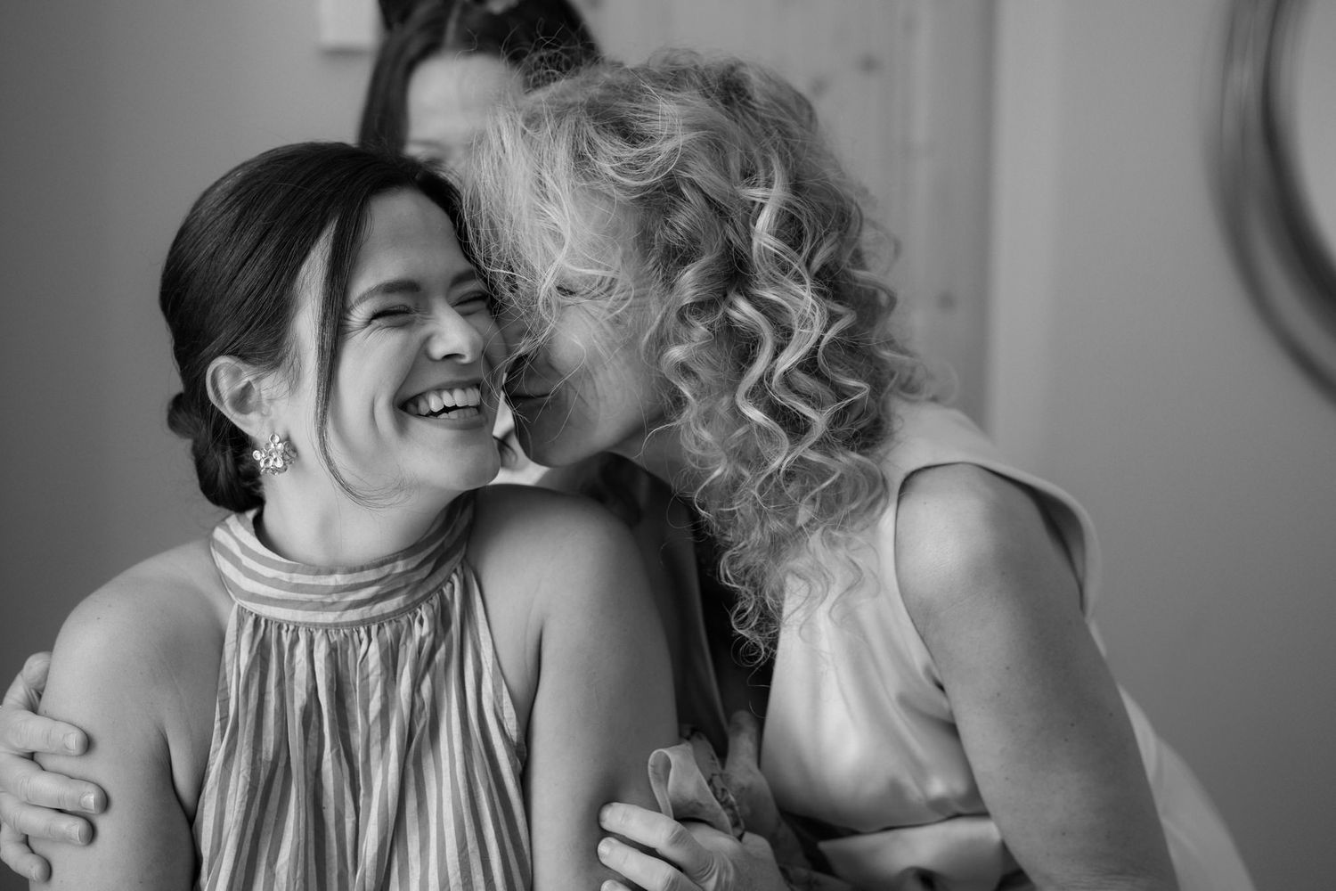 Intimate black and white candid moments showing laughter and embraces.