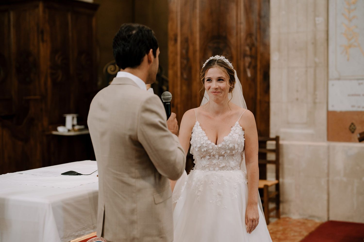 Traditional church wedding ceremony with wooden altar and religious iconography.